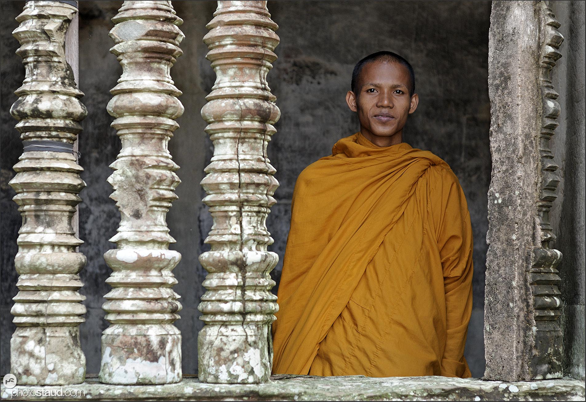 Stone columns and Buddhist monk in Angkor Wat, Cambodia