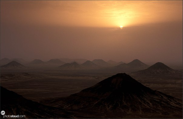 Sunset over the volcanic landscape of the Black Desert, Libyan Desert, Egypt